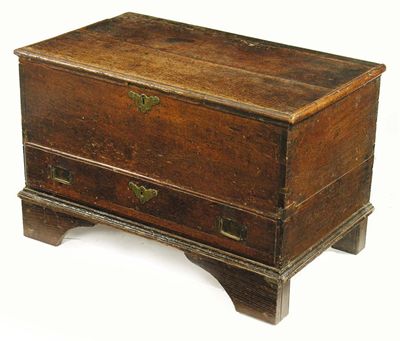 Appraisal: An oak chest the hinged moulded edge top to a