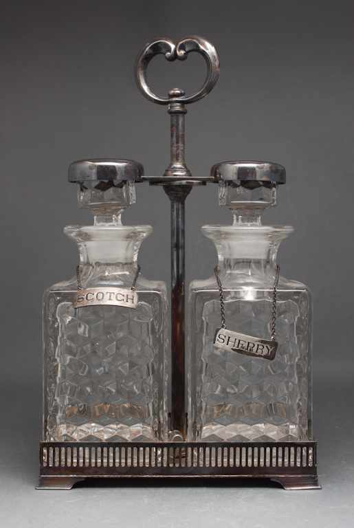 Appraisal: Silver-plated and molded glass two-bottle tantalus with silver liquor tags