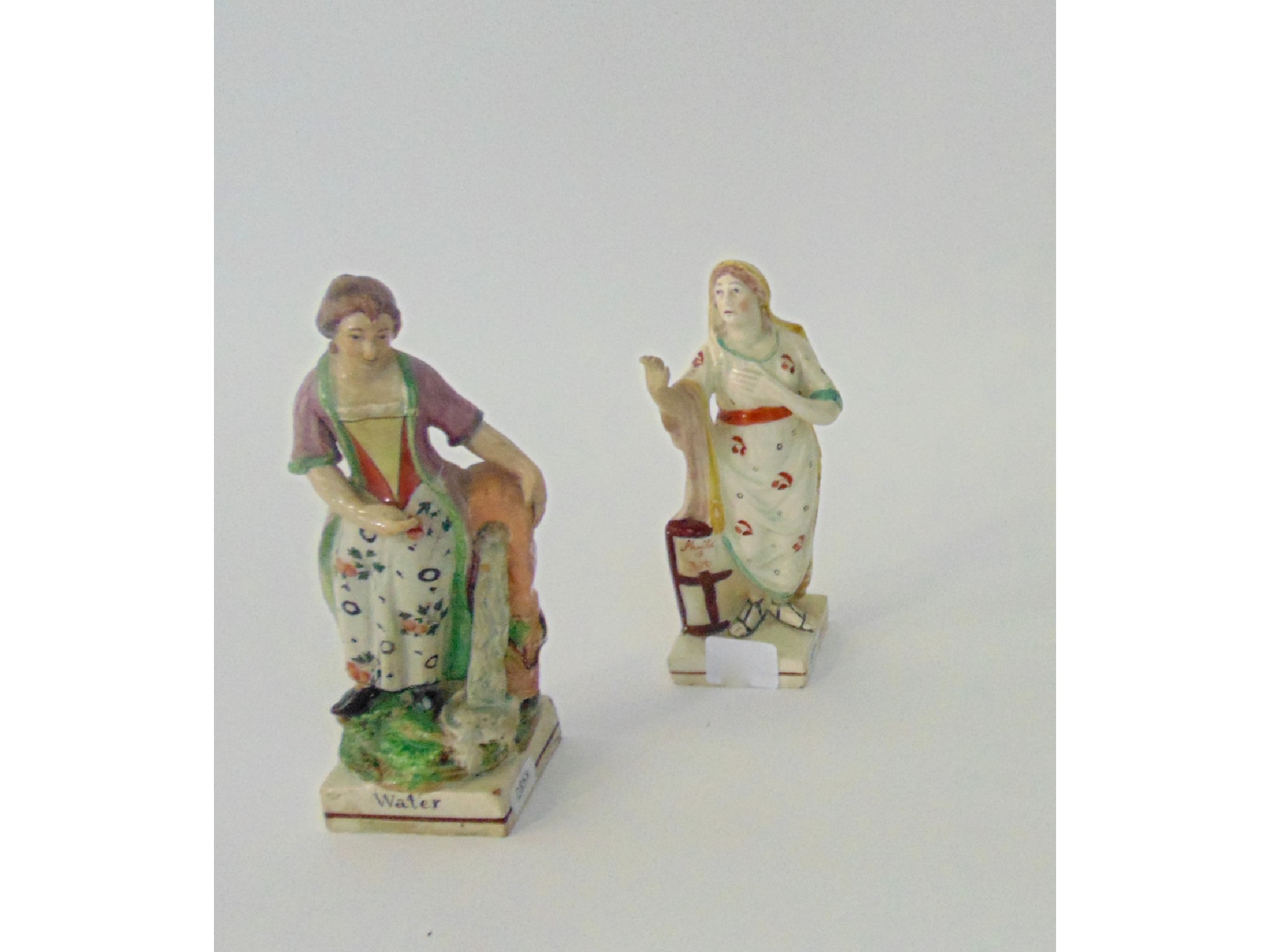 Appraisal: Two early th century Staffordshire figures one showing a classically