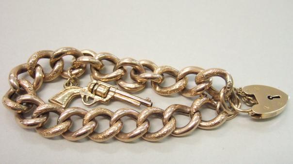 Appraisal: A gold decorated and plain curb link bracelet on a