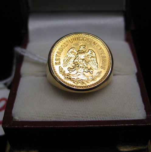 Appraisal: MEXICAN GOLD COIN RING The K yellow gold setting secures