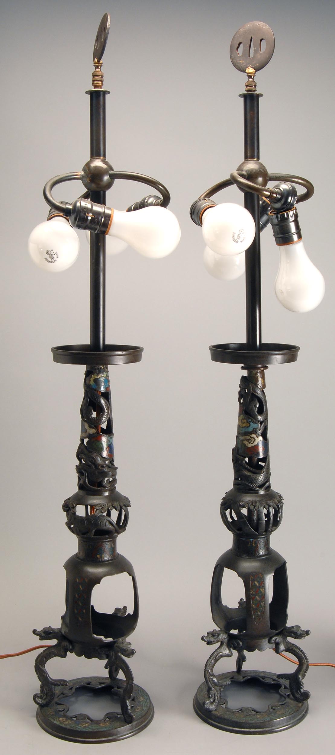 Appraisal: PAIR OF CHAMPLEV ENAMEL CANDLESTICK TABLE LAMPS Early th CenturyWith