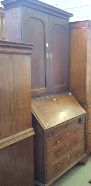 Appraisal: A George III bureau bookcase the top with moulded cornice