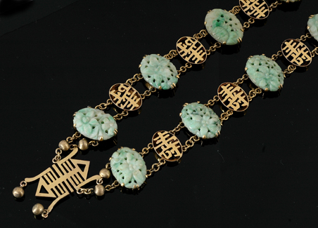 Appraisal: A gold and jadeite necklace Comprising eight oval carved jadeite