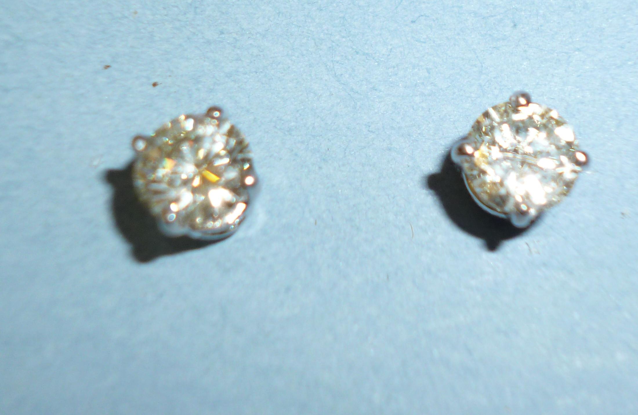 Appraisal: A PAIR OF DIAMOND STUD EARRINGS the brilliant cut stones