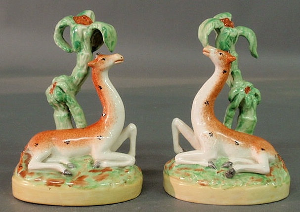 Appraisal: Rare pair of Staffordshire giraffes with palm trees h x