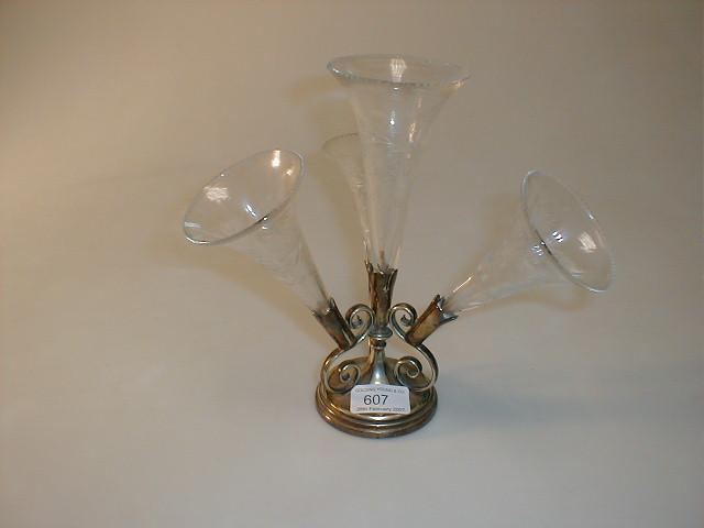 Appraisal: An Electroplate table epergne with four wheel cut clear glass