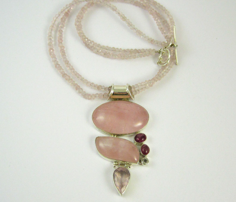 Appraisal: LIGHT PINK ROSE QUARTZ AND SILVER BEADED PENDANT NECKLACE with