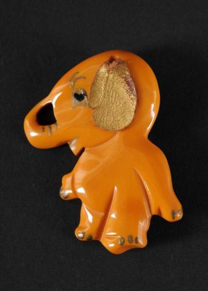 Appraisal: Bakelite Gold Elephant Pin with Leather Ear Condition Excellent Size