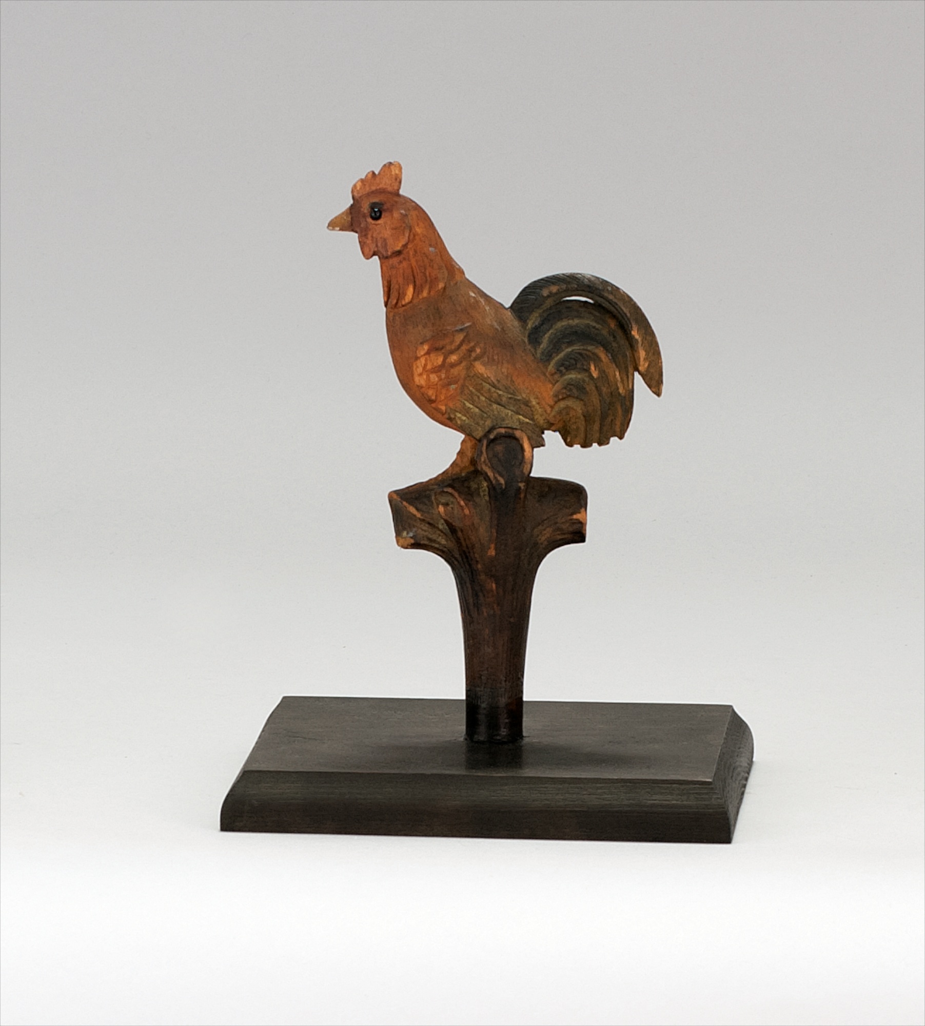 Appraisal: MINIATURE CARVING OF A ROOSTER th CenturyGlass eyes Standing on