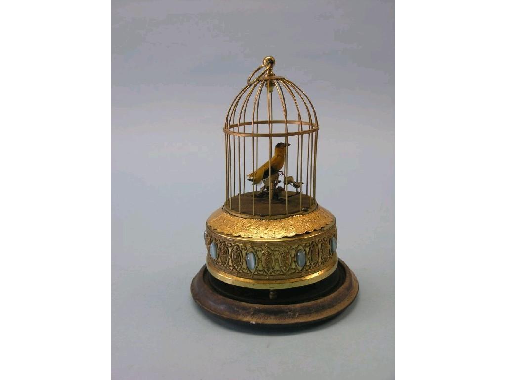 Appraisal: A late th century singing bird automaton bird within gilt-metal