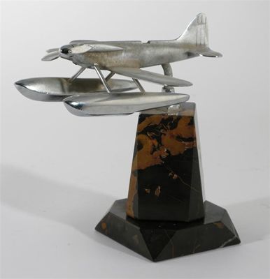 Appraisal: A polished metal flying boat car mascot mounted on black