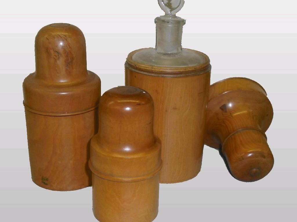 Appraisal: Three graduated Victorian treen chemist jar covers with glass bottle