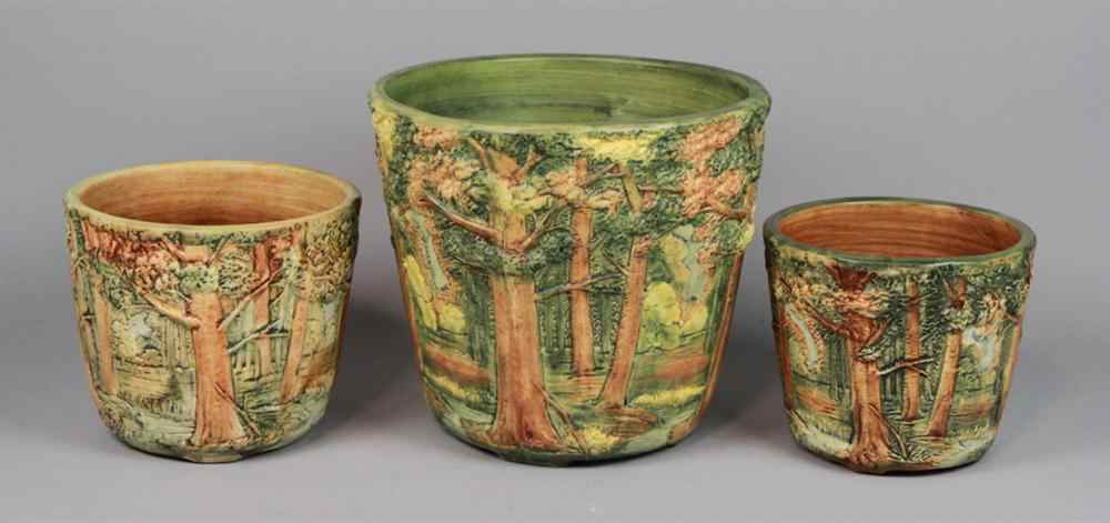 Appraisal: THREE WELLER POTTERY FOREST PATTERN PLANTERS with continuous molded relief