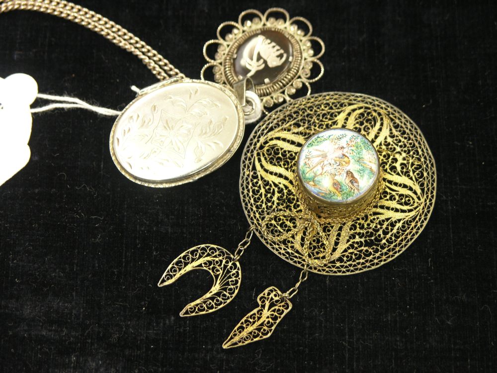 Appraisal: Two white metal pendants one on chain and a gilt