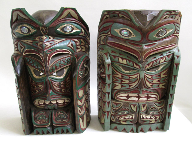 Appraisal: TWO INDIAN CARVED AND PAINTED MASKS of totemic figures having