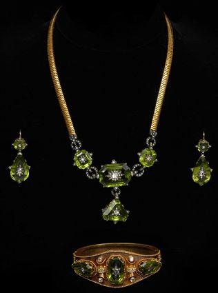 Appraisal: PERIDOT AND DIAMOND PARURE Matching necklace bracelet and drop earrings