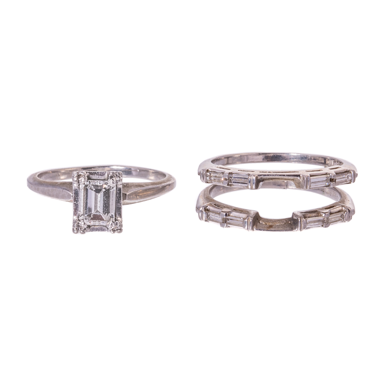 Appraisal: AN EMERALD-CUT DIAMOND RING ENHANCER IN PLATINUM Platinum ring featuring