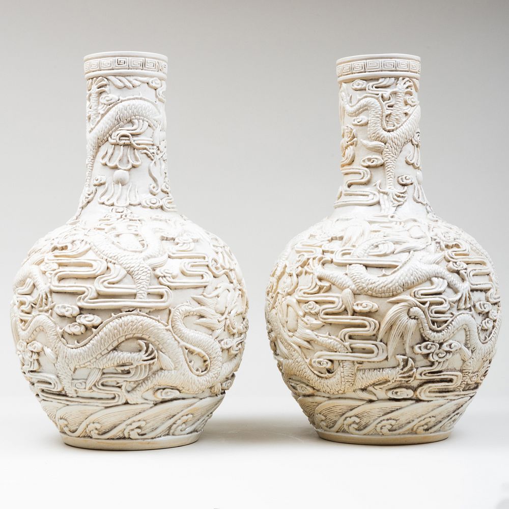 Appraisal: Pair of Chinese White Glazed Bottle Vases Molded with dragons