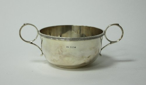 Appraisal: A silver porringer Walker Hall Sheffield with twin ring handles