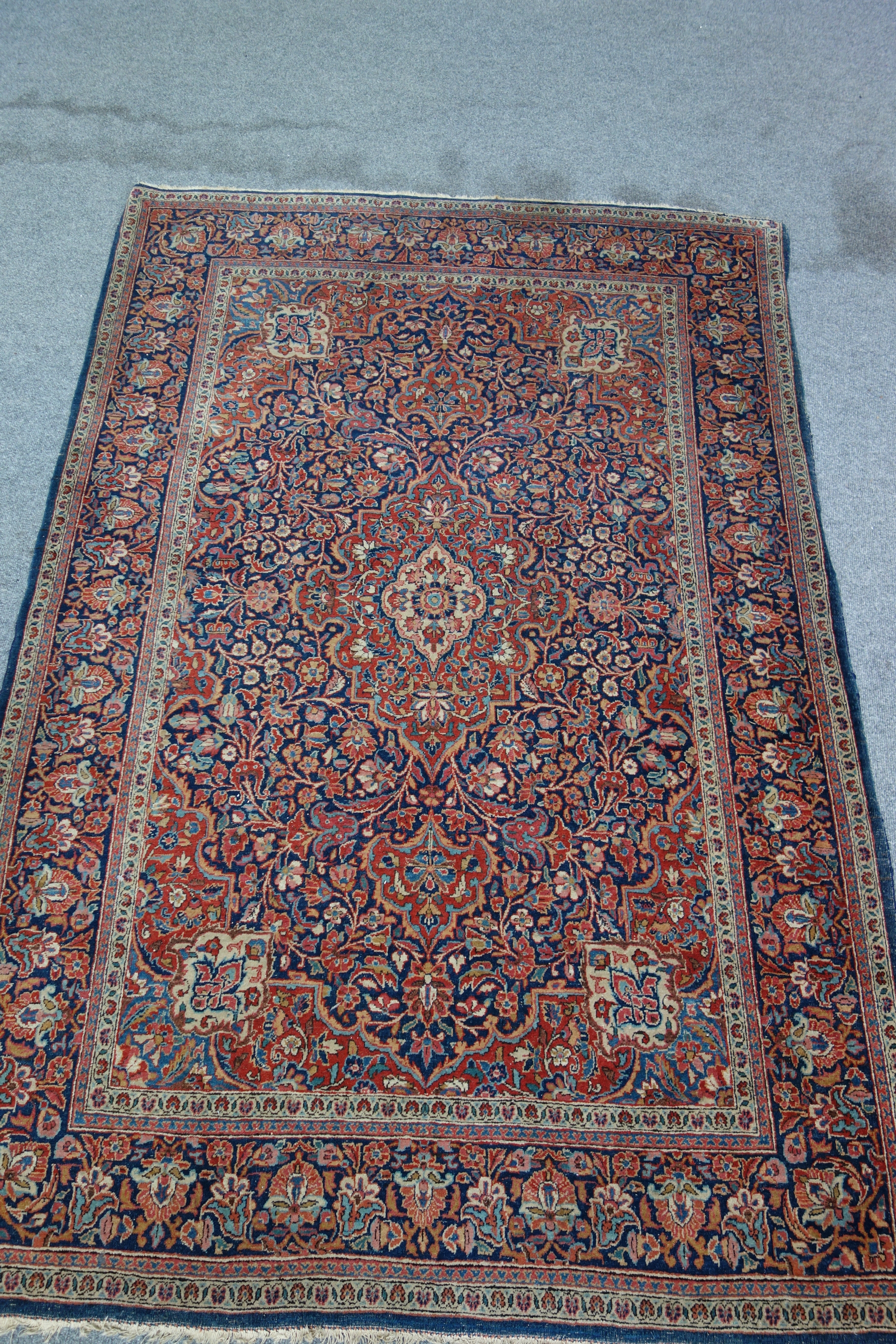 Appraisal: A Tabriz rug the blue ground with central red medallion