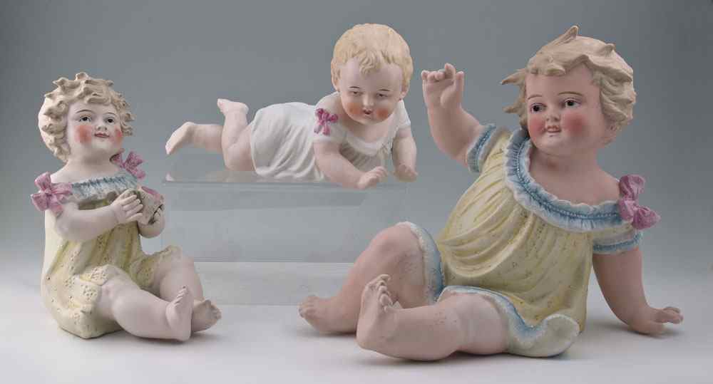 Appraisal: GERMAN BISQUE PIANO BABIES Three sizes three poses The larger