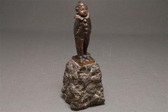 Appraisal: Continental patinated bronze figure of a young harlequin mounted on