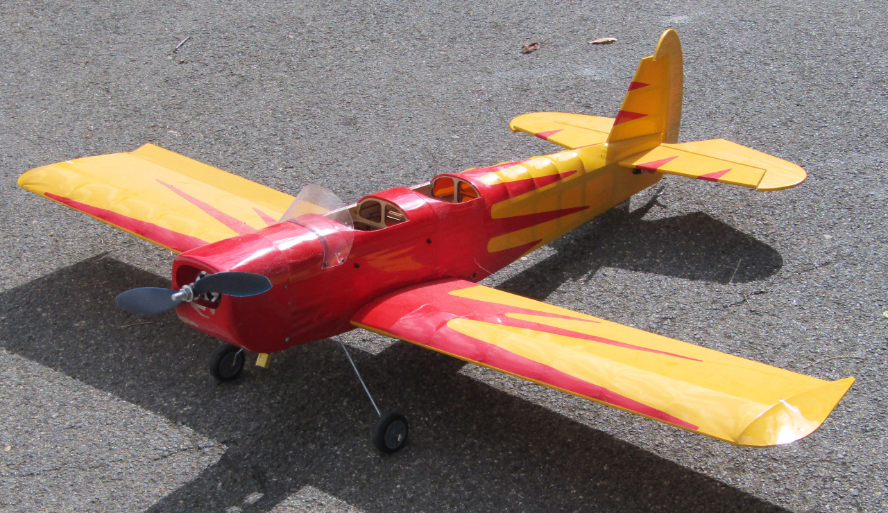 Appraisal: A remote controlled single propeller airplane with red and yellow