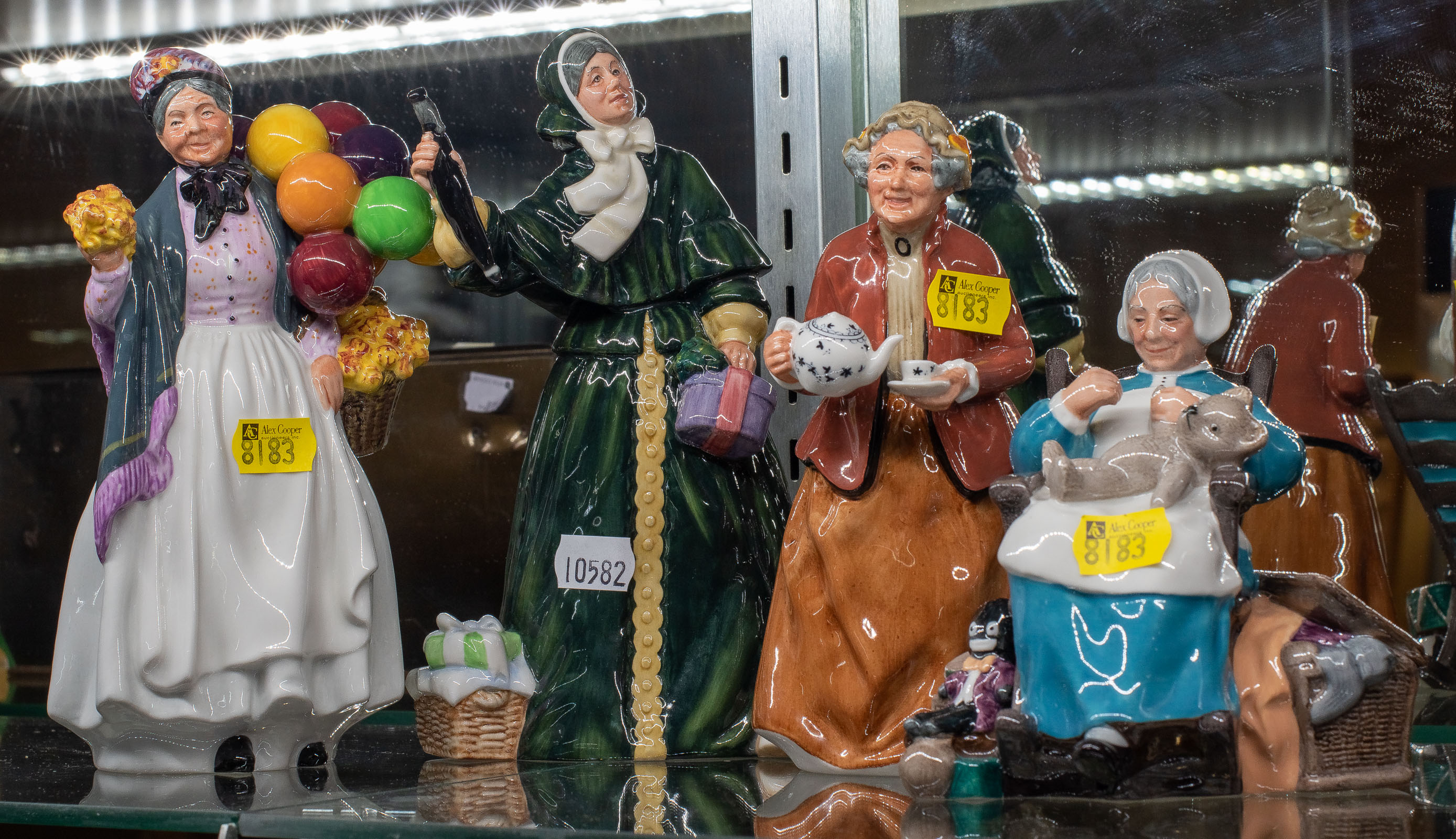 Appraisal: FOUR ROYAL DOULTON FIGURES Including Tea Time and Christmas Parcels