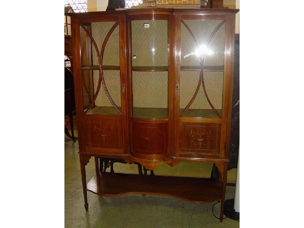 Appraisal: An Edwardian inlaid mahogany display cabinet the central bow front