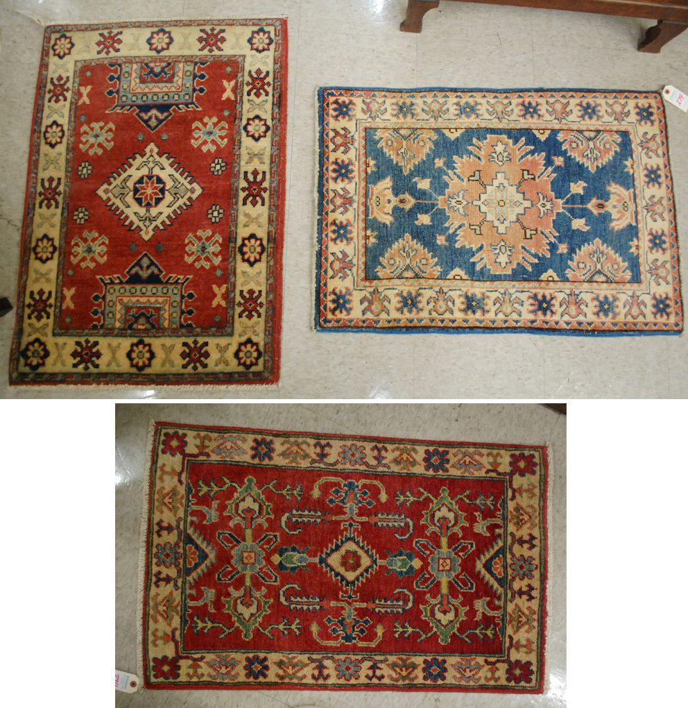 Appraisal: THREE HAND KNOTTED ORIENTAL MATS Pakistani Caucasians various patterns one