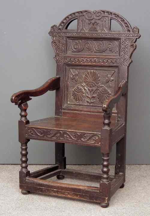 Appraisal: A th Century oak high back armchair with carved and