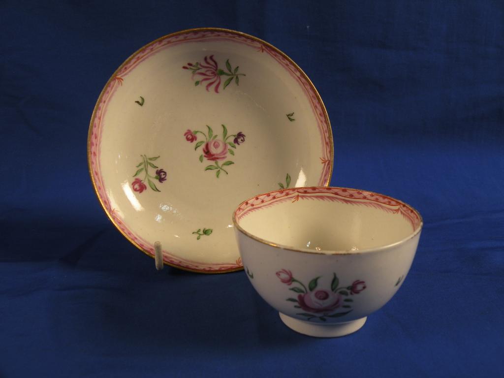 Appraisal: An thC Caughley tea bowl and saucer sparsely painted with