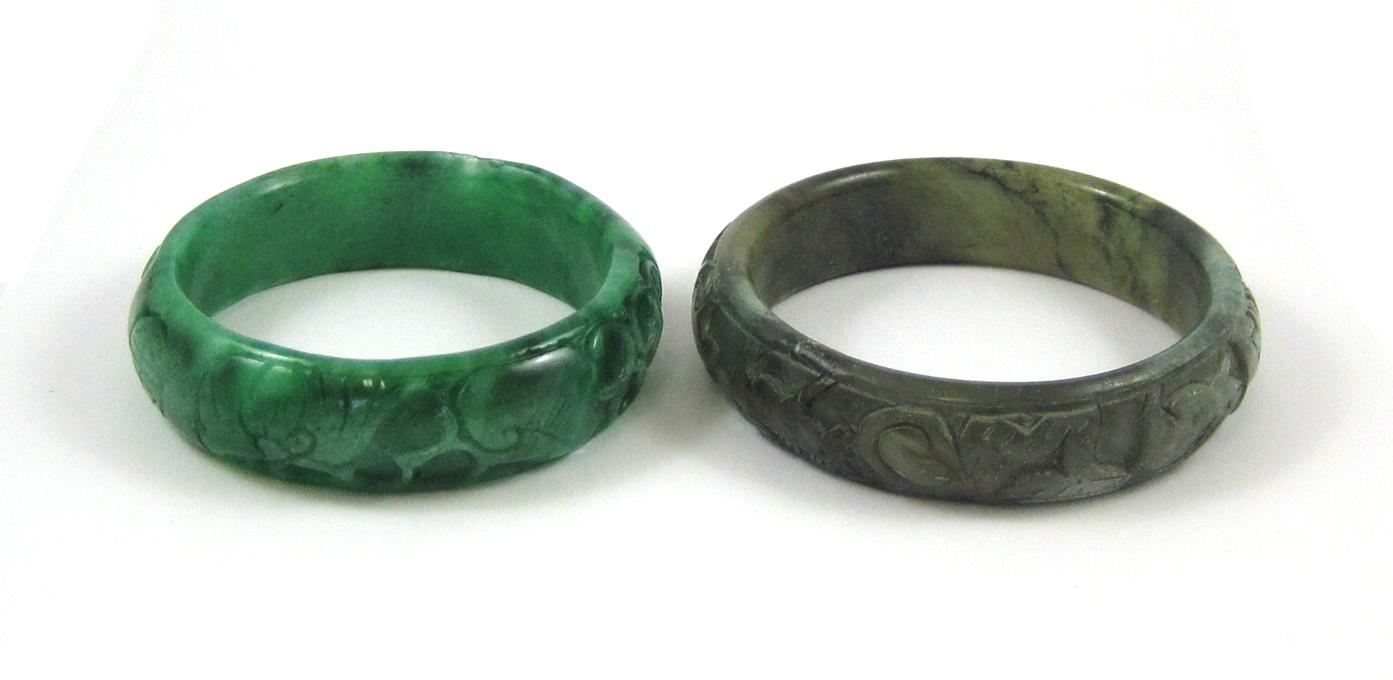 Appraisal: TWO CARVED NEPHRITE JADE BANGLES Both round carved nephrite bangles