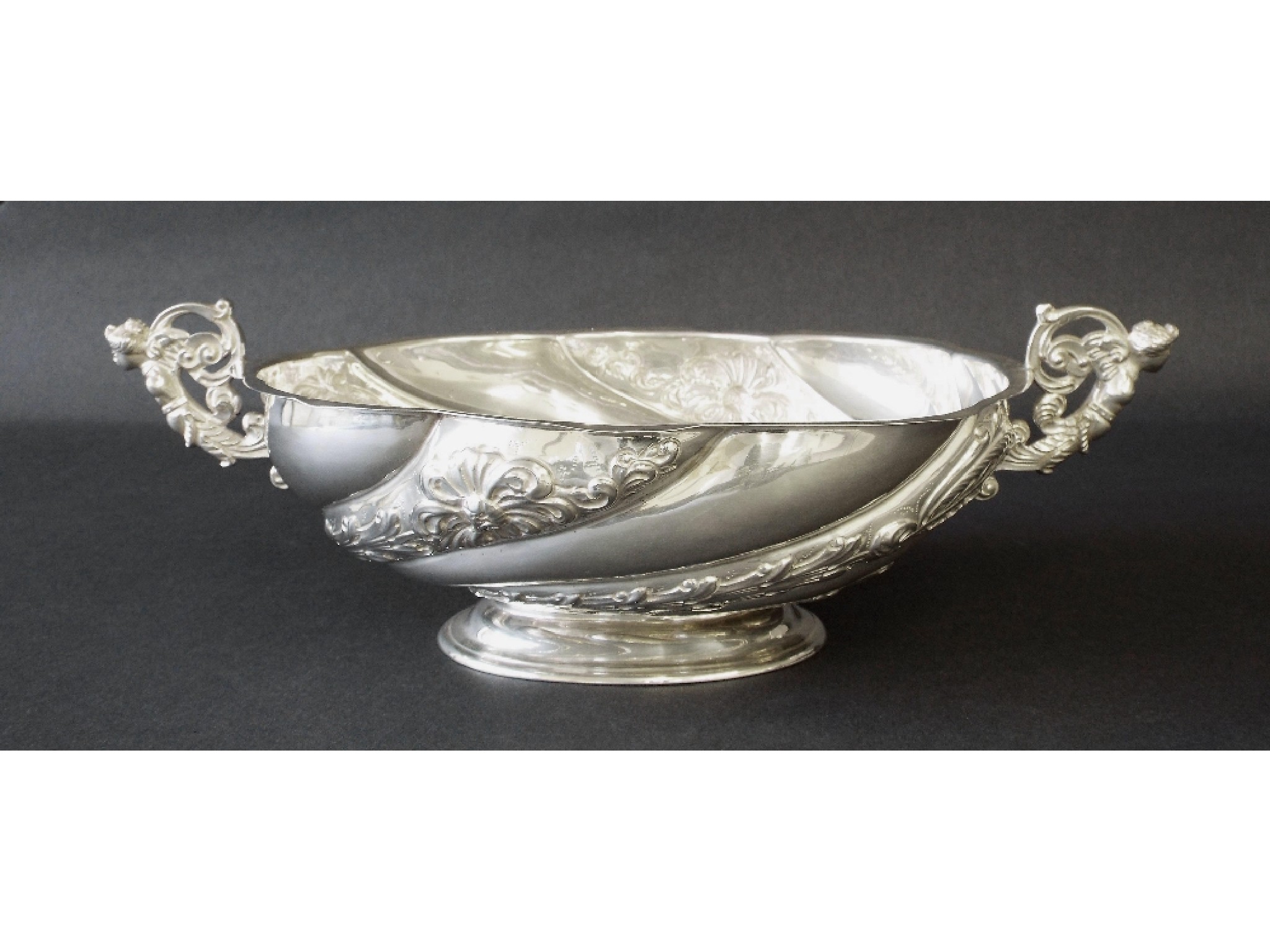 Appraisal: Early th century twin-handled wrythen fluted bonbon dish with embossed