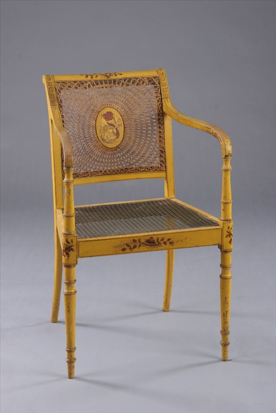 Appraisal: REGENCY PAINTED AND CANED OPEN-ARM CHAIR early th century Rolled-over