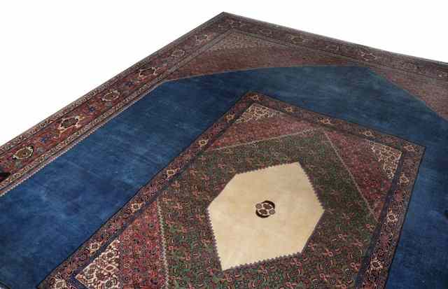 Appraisal: A CONTEMPORARY PERSIAN LARGE BLUE GROUND CARPET with central rug