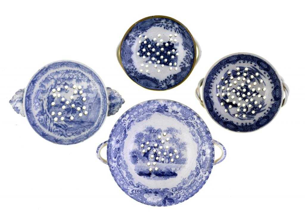 Appraisal: FOUR BLUE PRINTED EARTHENWARE TWO-HANDLED EGG DRAINERS AND OTHER STRAINERS