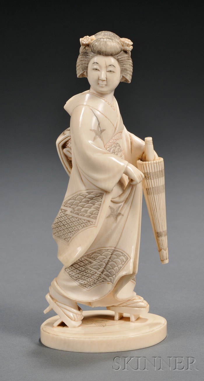 Appraisal: Ivory Carving Japan th century carved as a Geisha holding