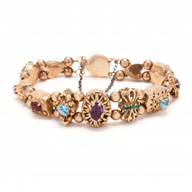 Appraisal: GOLD AND GEM-SET SLIDE BRACELET The double chain bracelet with