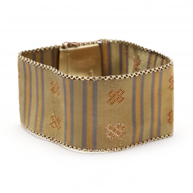 Appraisal: TRI-COLOR GOLD WIDE WOVEN BRACELET In a woven tri-color gold