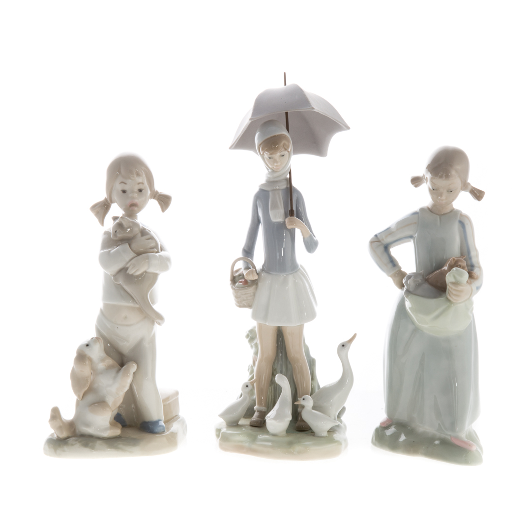 Appraisal: Three Lladro porcelain figures including Nao figure of a girl