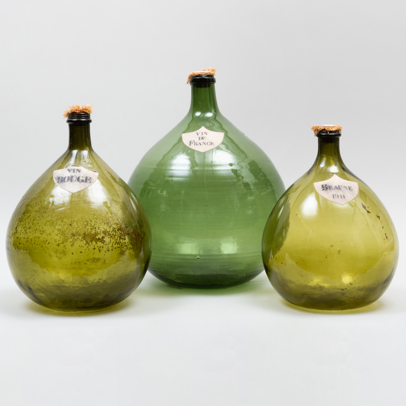 Appraisal: THREE LARGE FRENCH GLASS WINE DEMIJOHNS With paper labels The