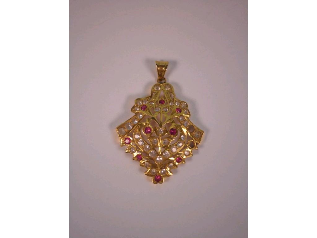 Appraisal: An Asian design lozenge shaped pendant set with red and