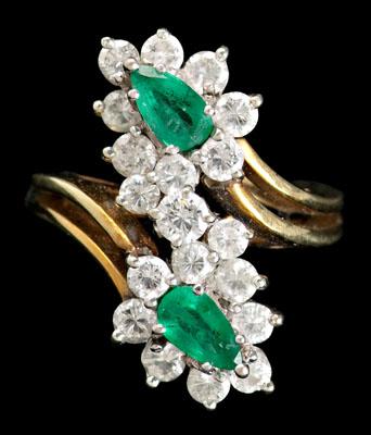 Appraisal: Emerald and diamond ring by pass design set with two