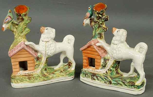 Appraisal: Pair of th c Staffordshire spill vases with poodles chained