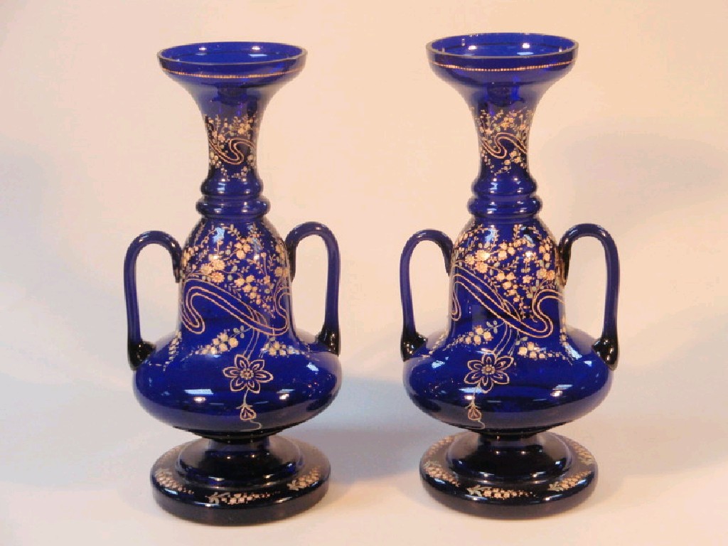 Appraisal: A pair of late thC Bristol blue glass two-handled baluster