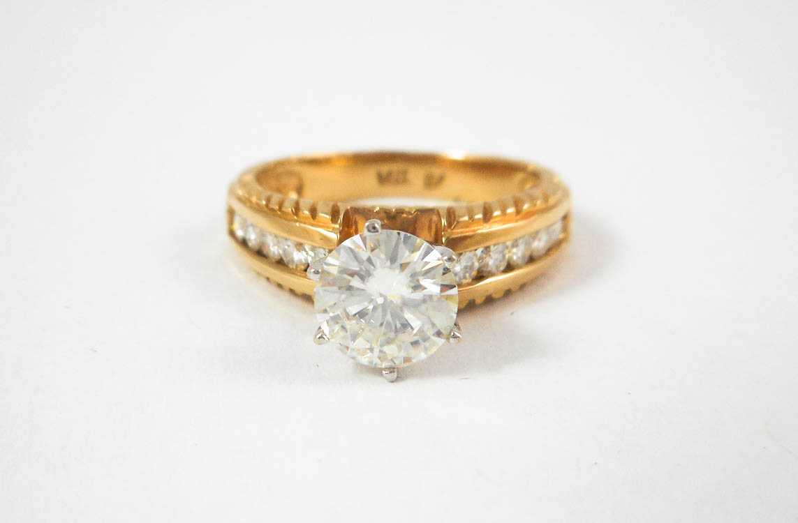 Appraisal: MOISSANITE AND FOURTEEN KARAT GOLD RING with five round-cut diamonds