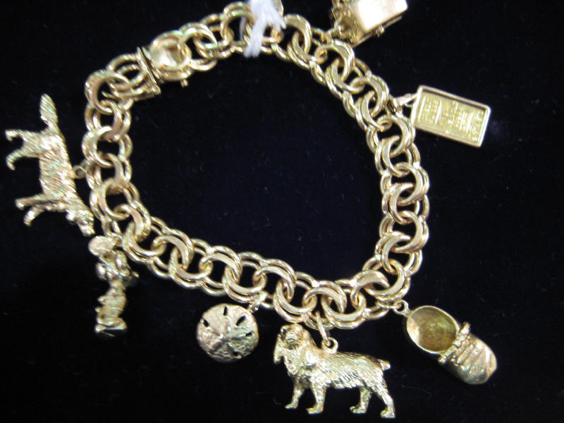 Appraisal: GOLD CHARM BRACELET k yellow gold with eight assorted novelty