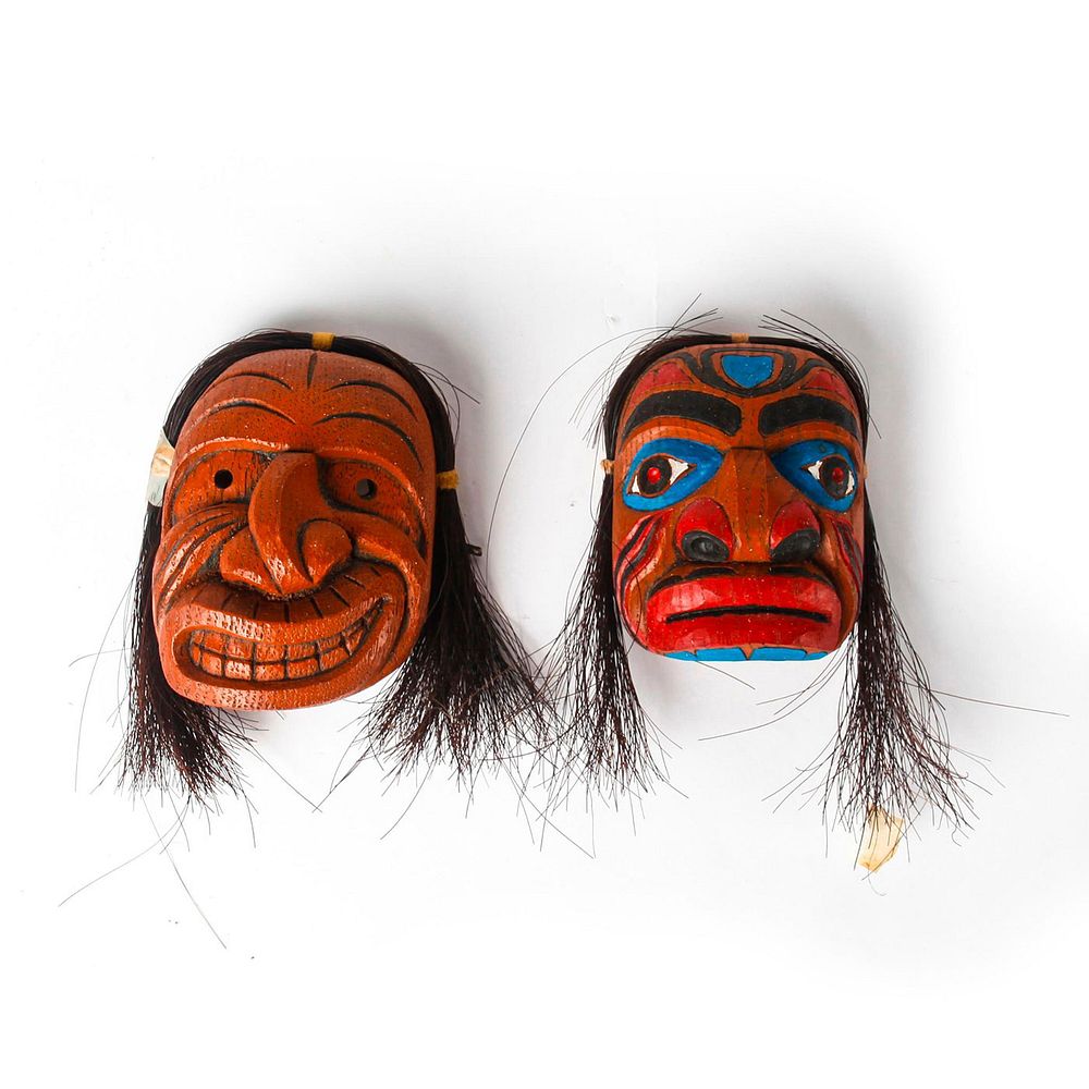 Appraisal: PAIR OF RESIN TRIBAL MASKS One mask with grimacing expression